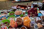 Thailand, Locals sell fruits, food and products at Damnoen Saduak floating market near Bangkok